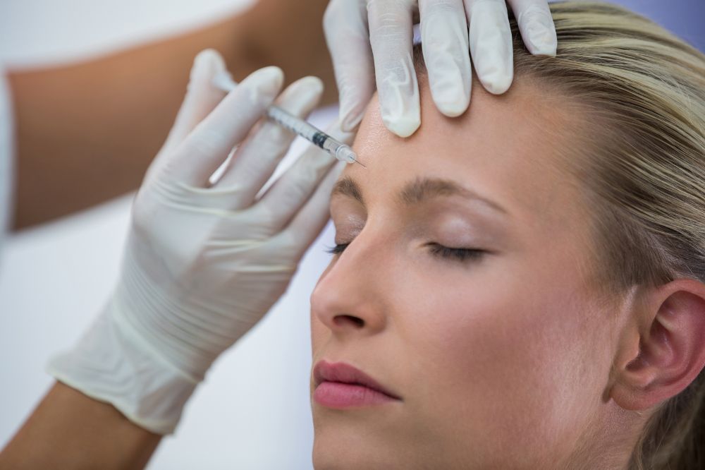 a woman is getting botox treatment