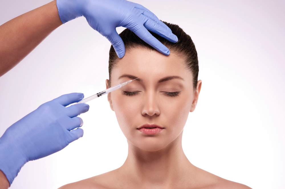 a woman is getting botox treatment
